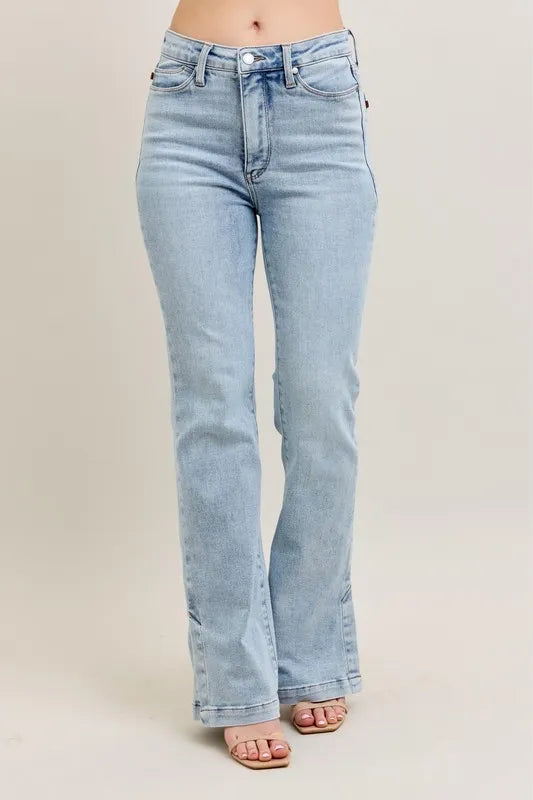 Side view showcasing the fit and side slit detail of Judy Blue Full Size Tummy Control Vintage Wash Side Slit Slim Boot Jeans Plus Size.