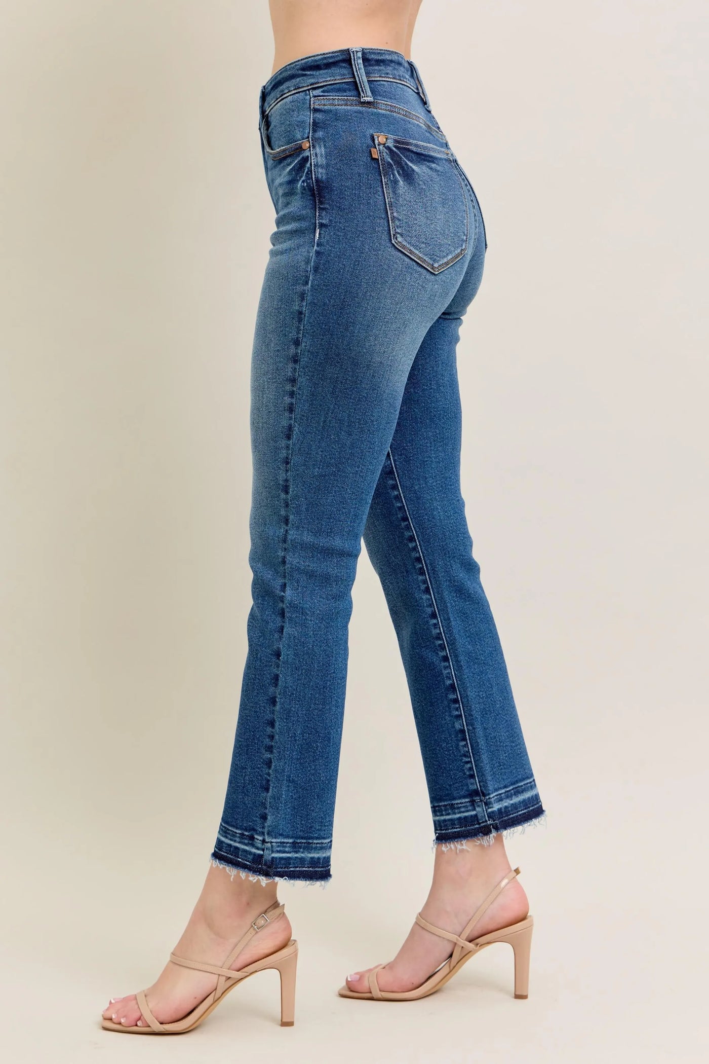 Angled front view of Judy Blue Full Size High-Waisted Vintage Wash Release Hem Kick Flare Jeans Plus Size, showcasing the silhouette.