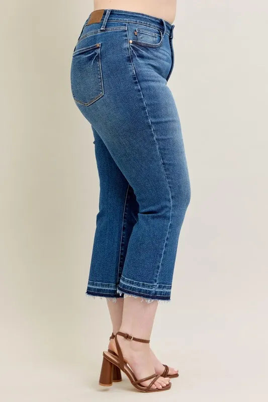 Styled front view of Judy Blue Full Size High-Waisted Vintage Wash Release Hem Kick Flare Jeans Plus Size with accessories.
