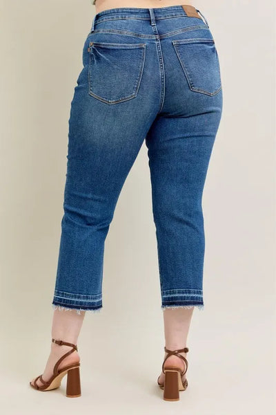 Styled side view of Judy Blue Full Size High-Waisted Vintage Wash Release Hem Kick Flare Jeans Plus Size, paired with a top.