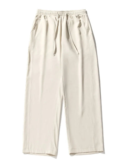 Side view showcasing the fit of Men's Drawstring Wide Leg Pants in Ivory.