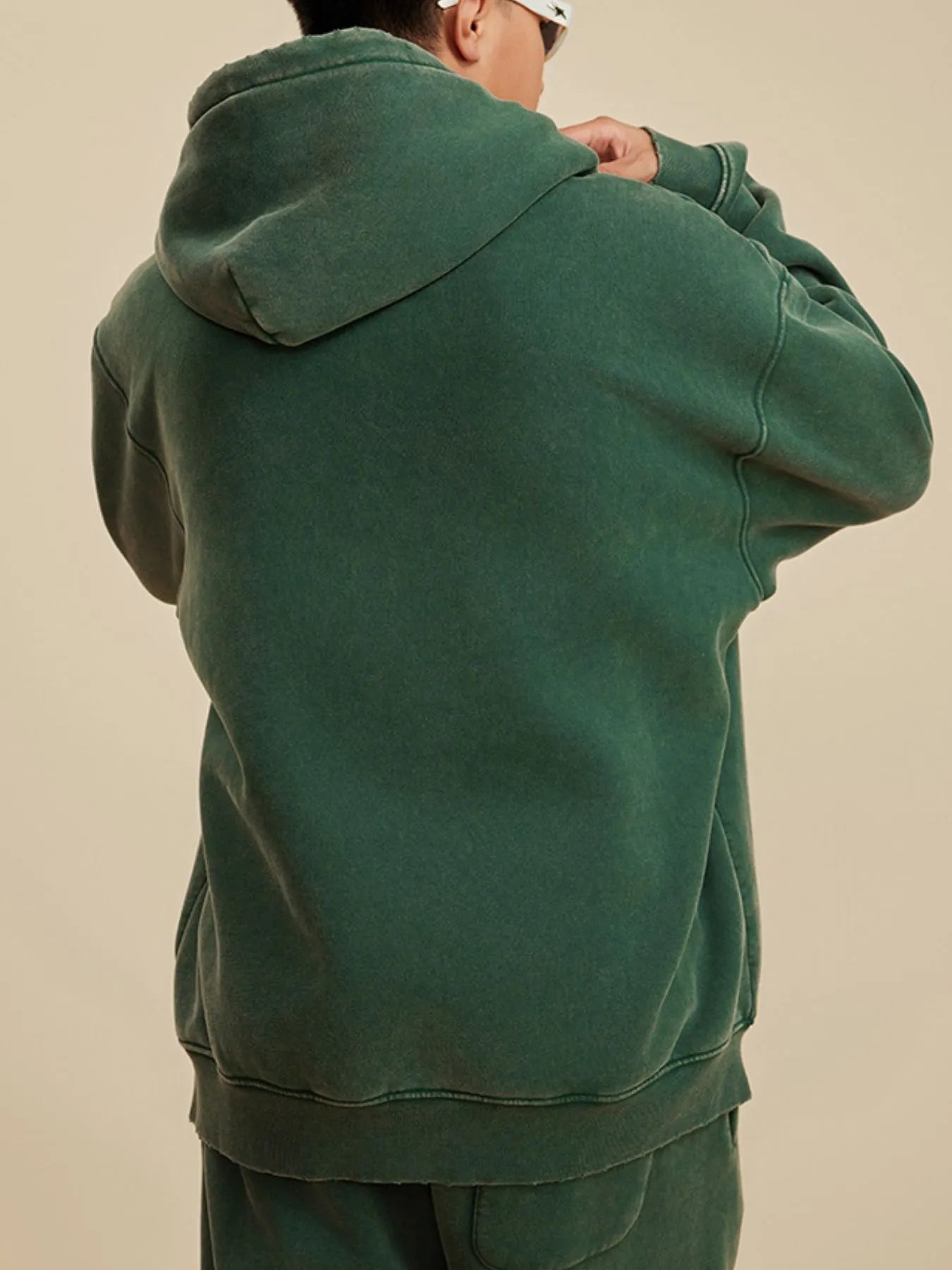 Back view highlighting the design of Men's Kangaroo Pocket Dropped Shoulder Hoodie in D.green.
