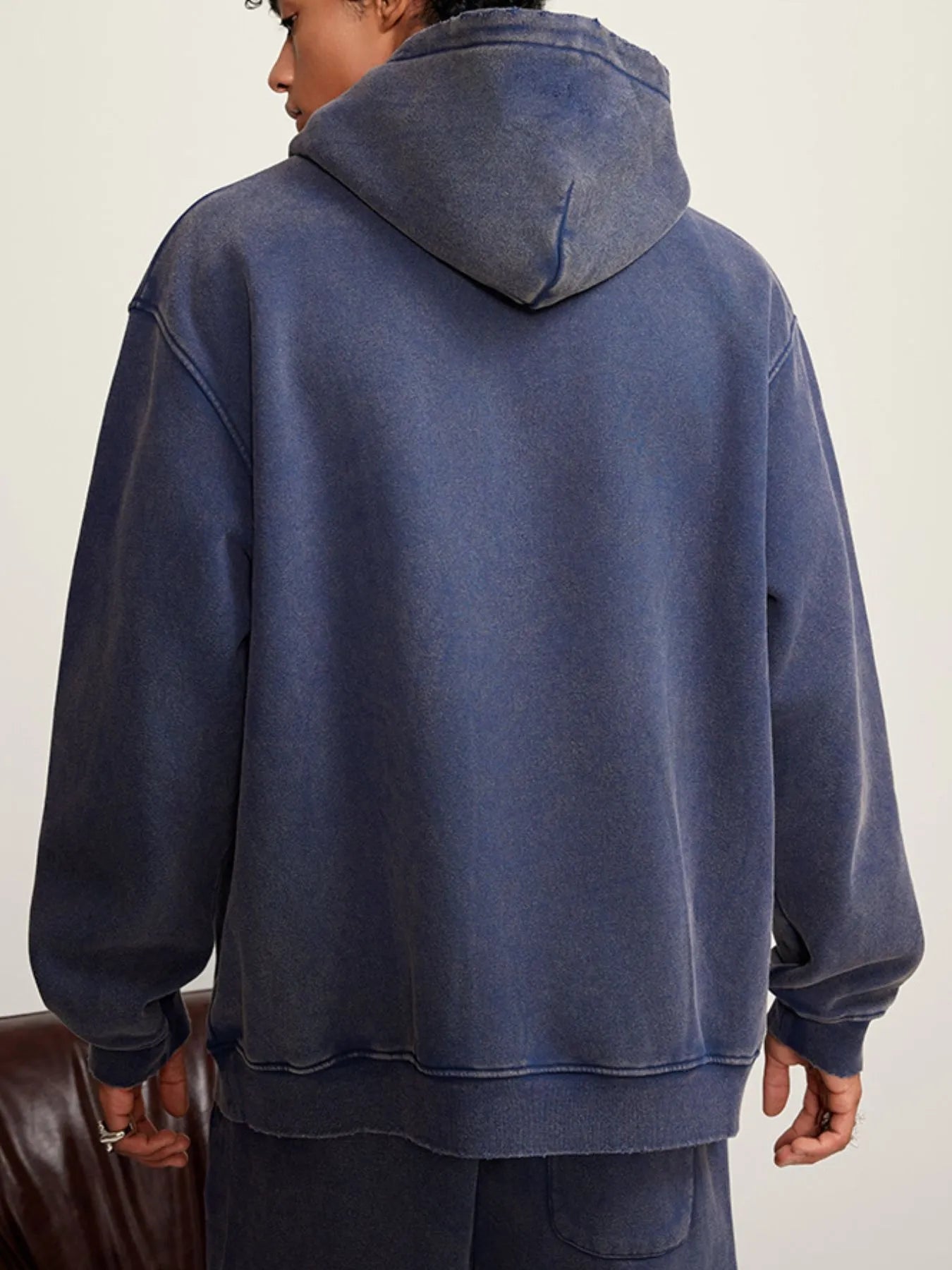 Back view highlighting the design of Men's Kangaroo Pocket Dropped Shoulder Hoodie in Sapphire Blue.