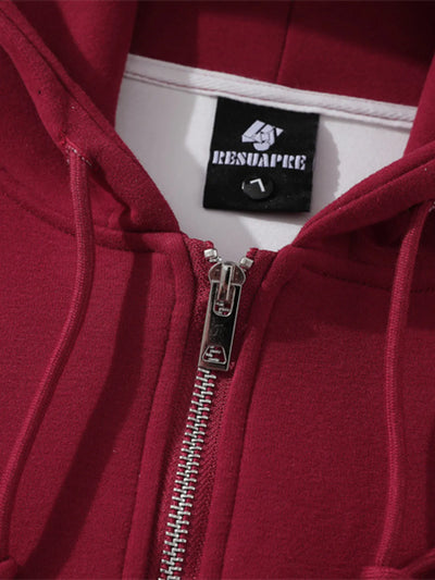 Close-up of the zipper detail on Men's Zip-Up Hooded Jacket in Red with graphic design.
