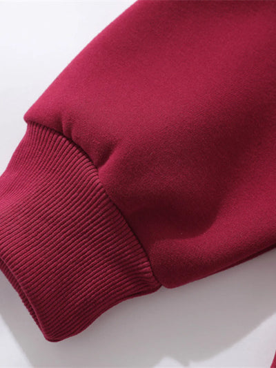 Model wearing Men's Zip-Up Hooded Jacket in Red with graphic design.