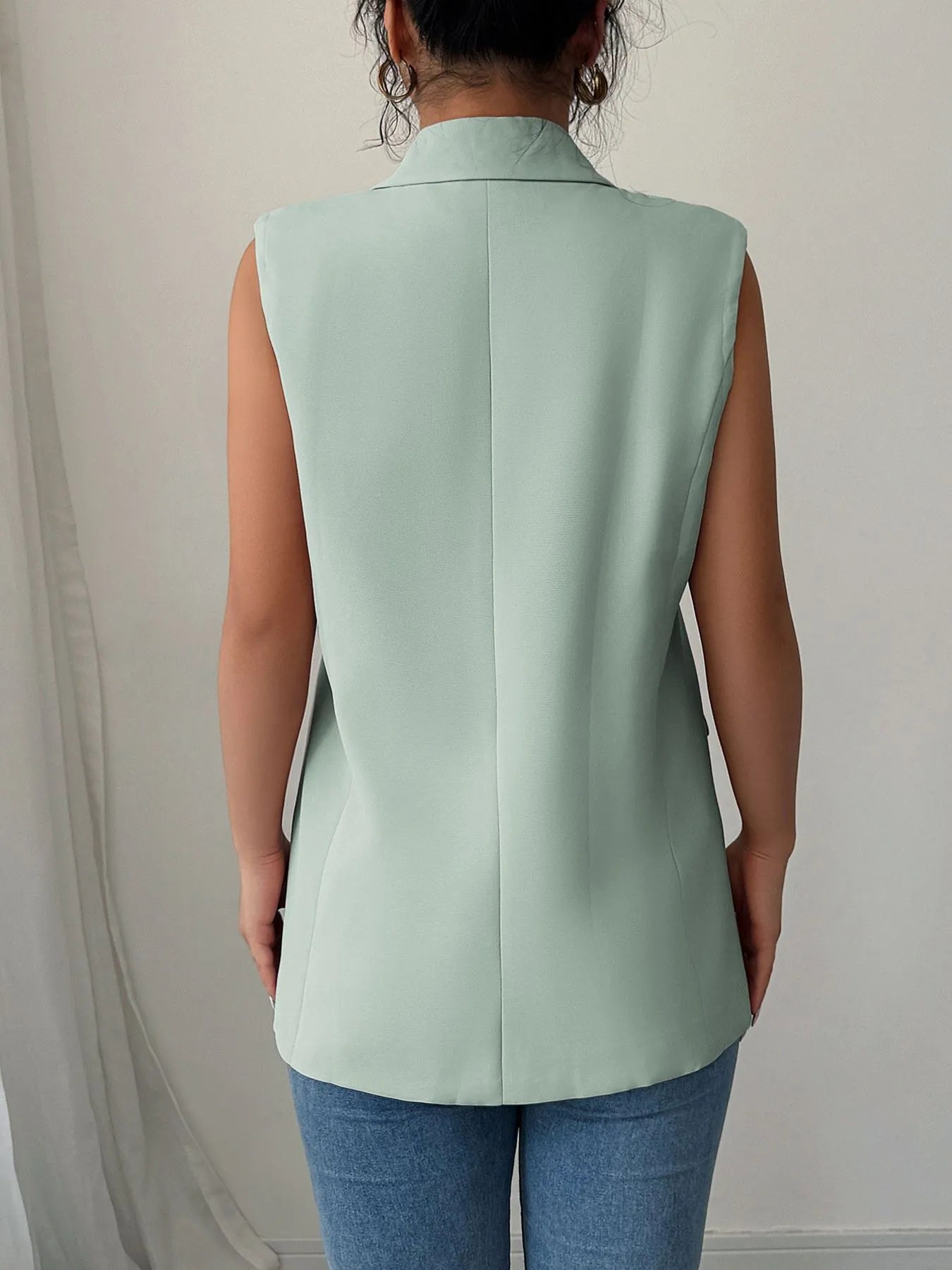 Side view showcasing the fit of One Button Sleeveless Blazer in Sage.