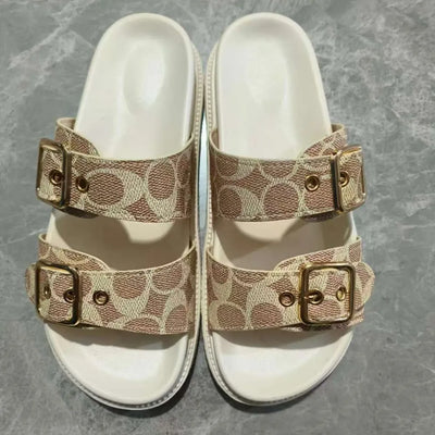 Close-up detail of buckles on beige open toe double buckle sandals