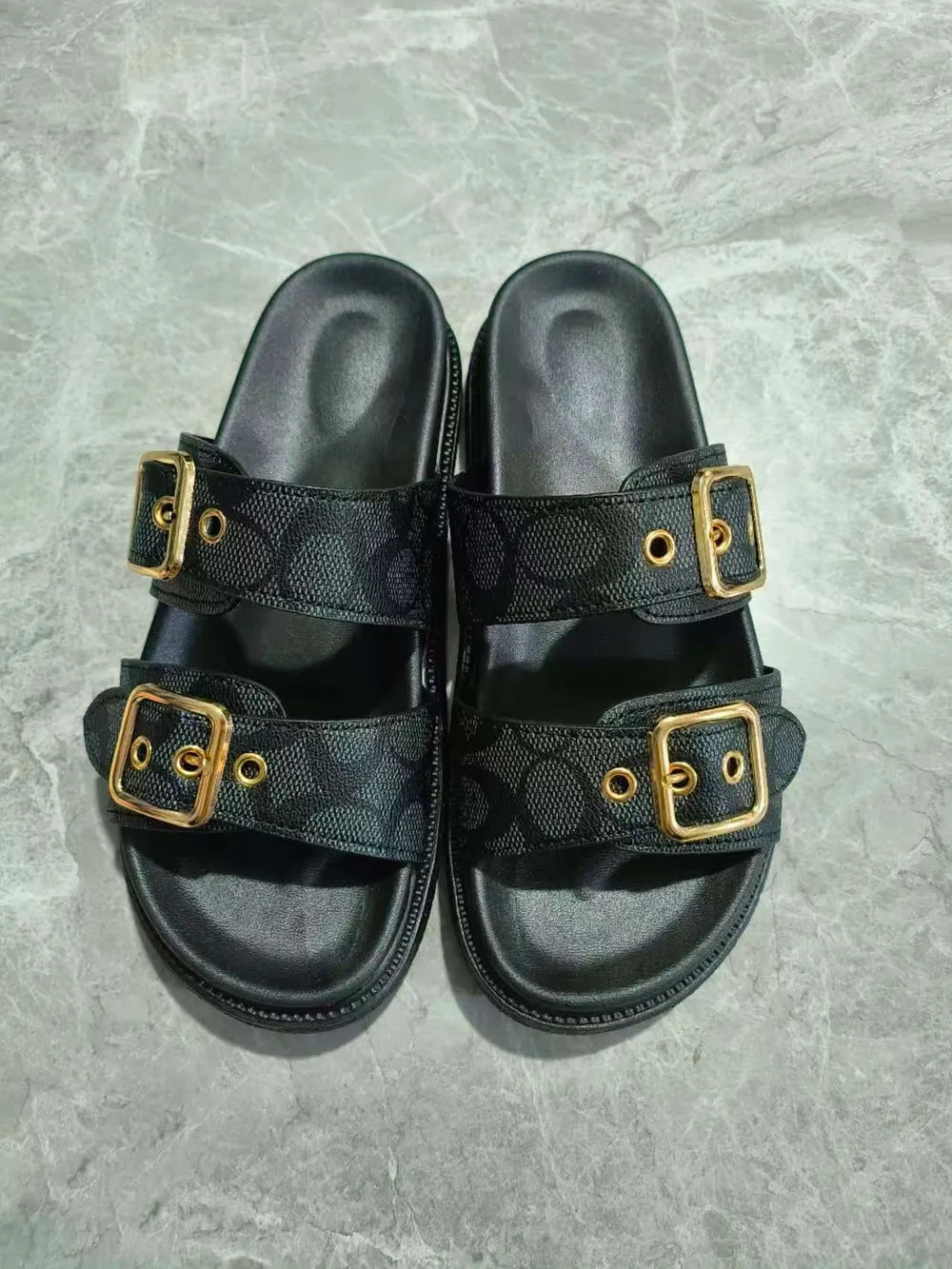 Close-up detail of buckles on black open toe double buckle sandals