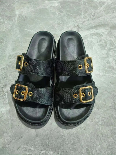 Close-up detail of buckles on black open toe double buckle sandals