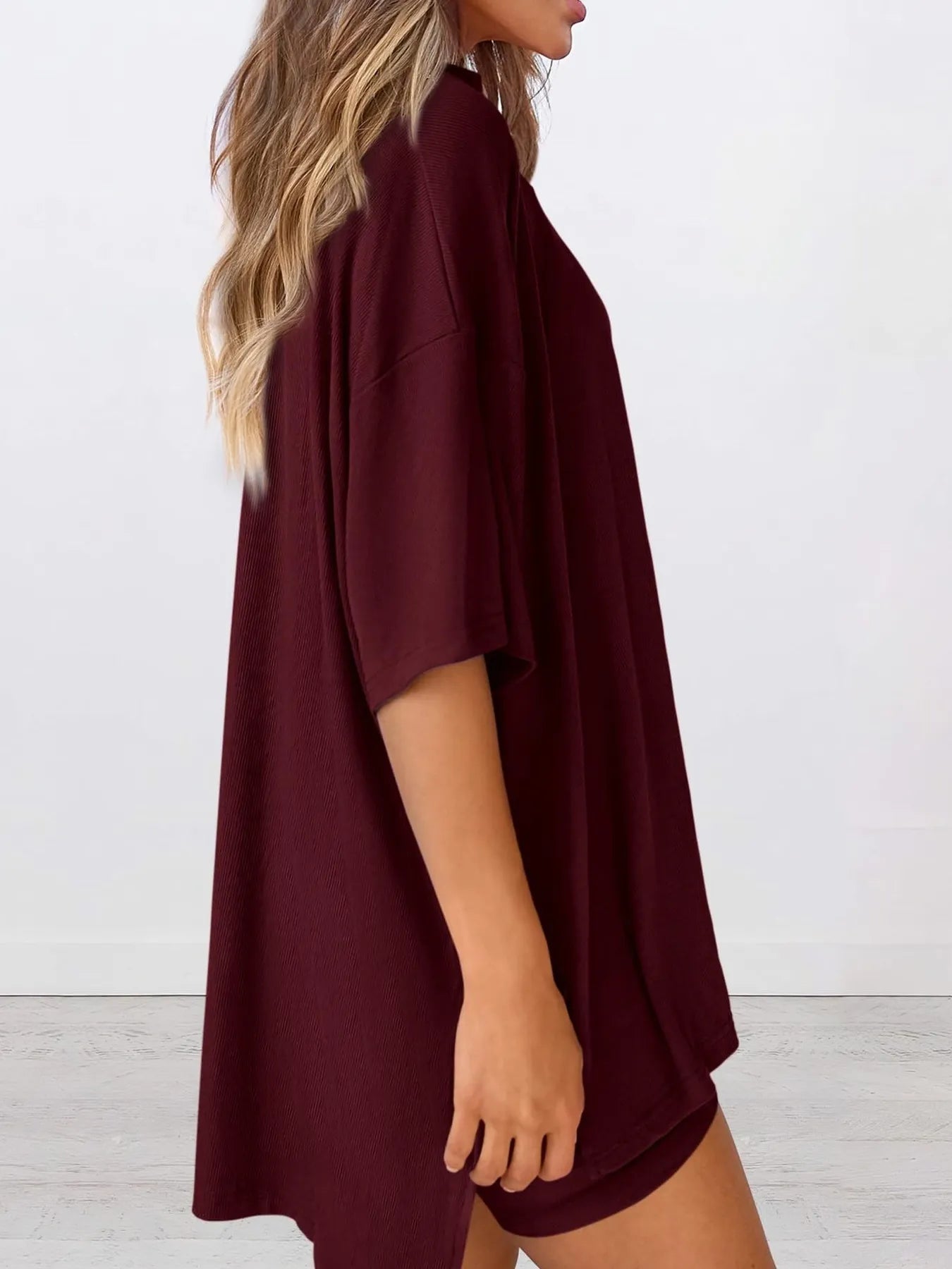 Angled front view of model wearing Full Size Oversized Slit Round Neck Lounge Set, showing relaxed oversized fit.
