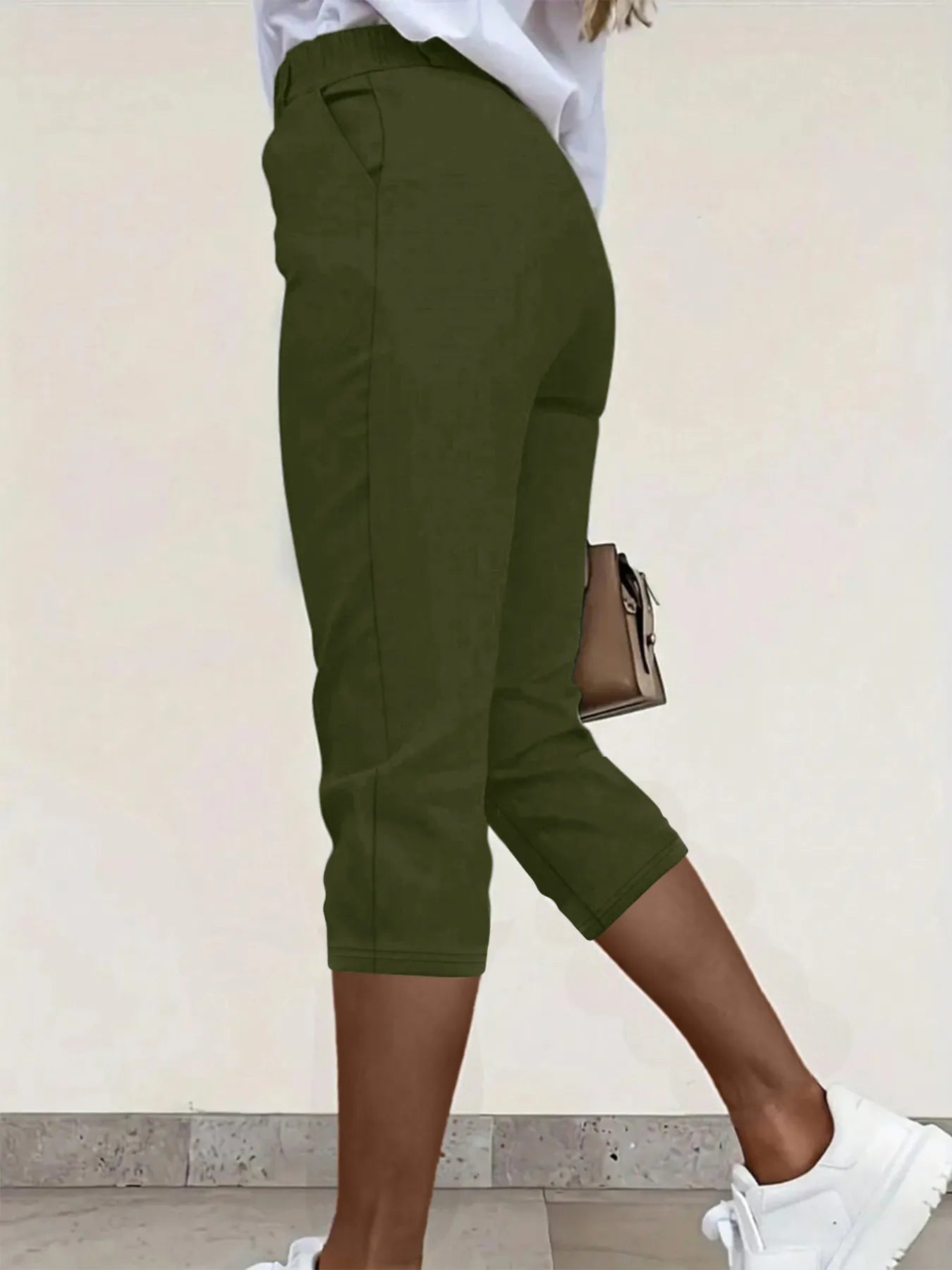 Close-up of pleat and pocket detail on black forest pleated pants