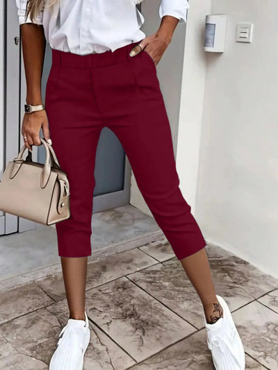Front view of pleated detail pants in burgundy