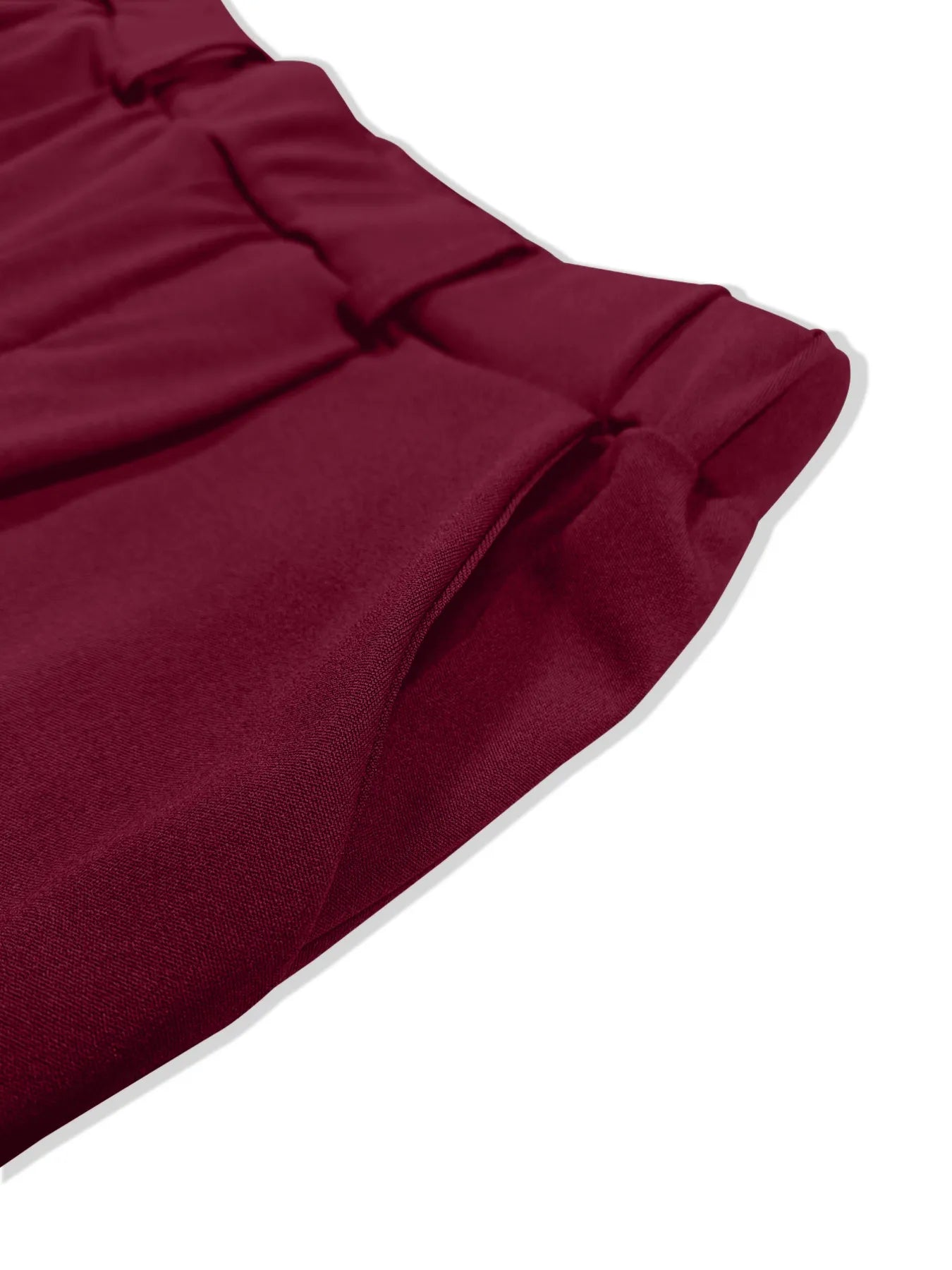 Close-up of pleat and pocket detail on burgundy pleated pants
