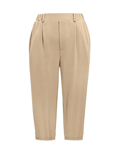 Close-up of pleat and pocket detail on tan pleated pants