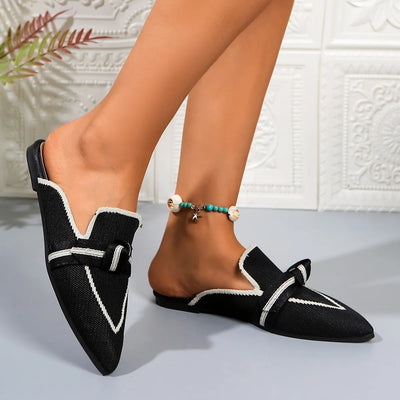 Side view of black point toe flat slip-on shoes