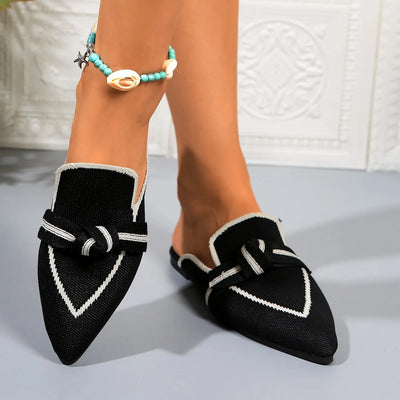 Close-up of the pointed toe design on black slip-on flats