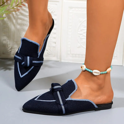 Close-up of the pointed toe design on blue slip-on flats