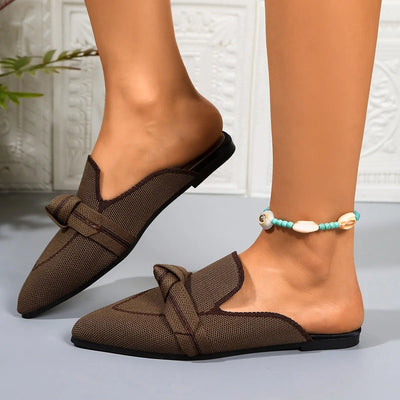 Close-up of the pointed toe design on brown slip-on flats