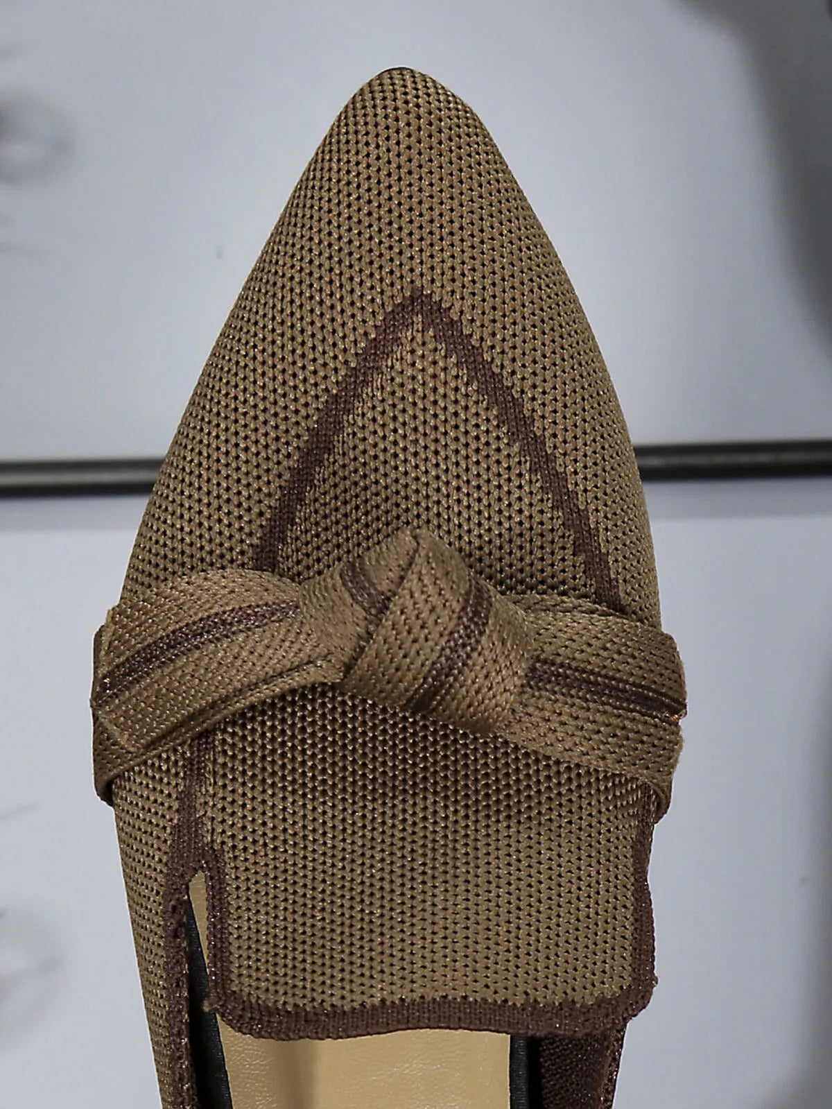 Top-down view of brown point toe flat slip-on shoes