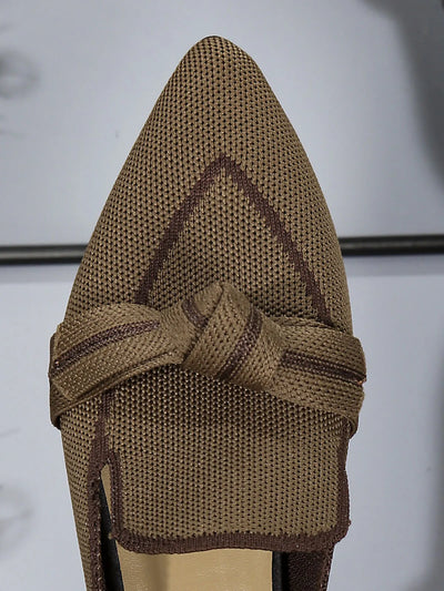 Top-down view of brown point toe flat slip-on shoes