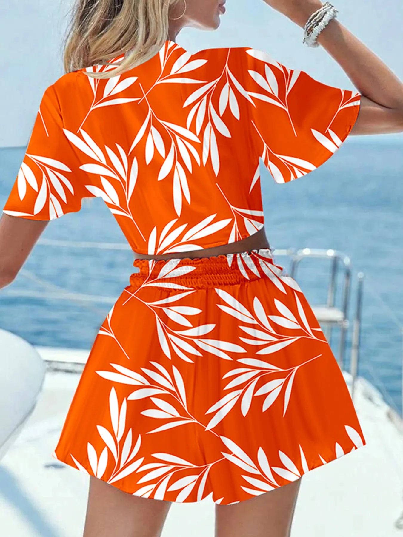 Back view highlighting the design of Printed Tie Front Top and Shorts Set in Orange