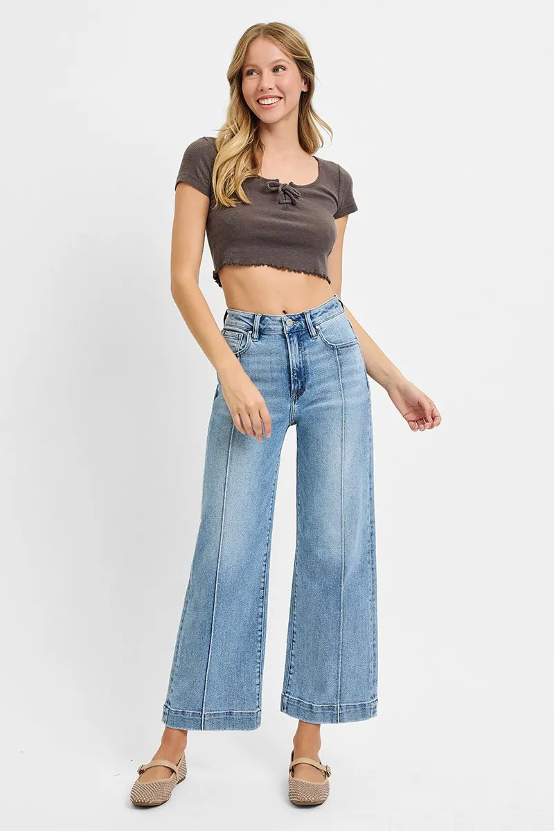 Model wearing Risen High Rise Crop Wide Leg Jeans, showcasing the chic high-rise and cropped wide-leg design.