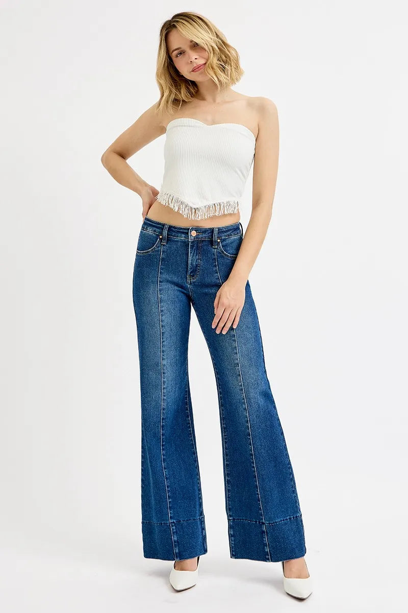 Model wearing Risen Full Size Tummy Control Mid Rise Ankle Wide Flare Jeans, showcasing the flattering fit and wide flare design.
