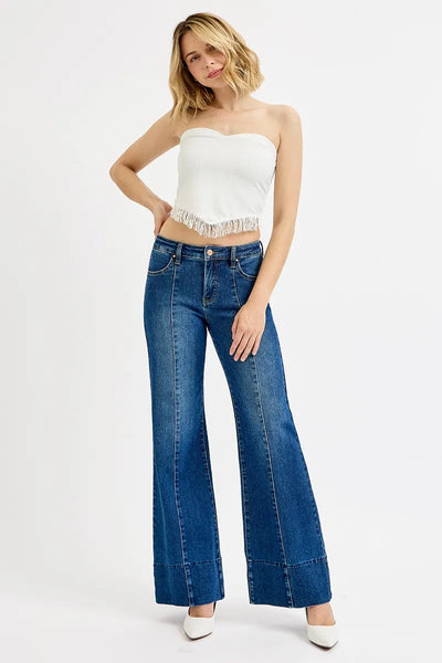 Model wearing Risen Full Size Tummy Control Mid Rise Ankle Wide Flare Jeans, showcasing the flattering fit and wide flare design.