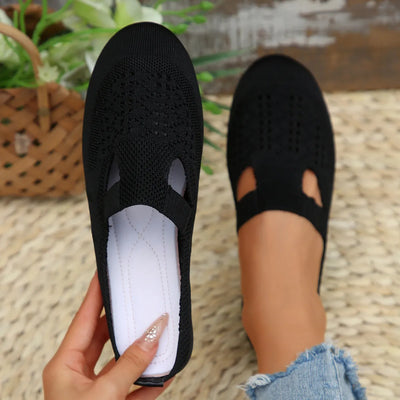 Side view of model wearing Round Toe Flat Slip-Ons, highlighting the sleek and comfortable design.