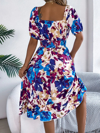 Angled back view of Ruffled Hem Smocked Floral Short Sleeve Midi Dress, showcasing the ruffled hem and flattering fit.