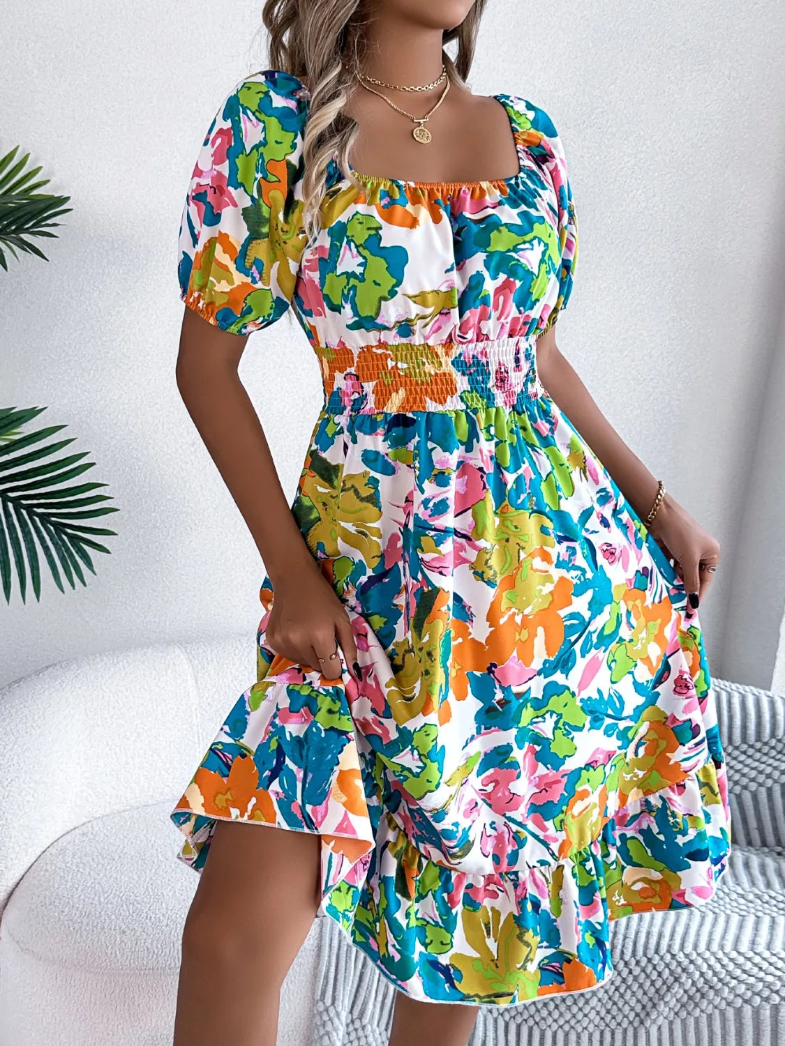 Full-body view of model wearing Ruffled Hem Smocked Floral Short Sleeve Midi Dress, showcasing the overall look and fit.