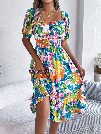 Side view of model wearing Ruffled Hem Smocked Floral Short Sleeve Midi Dress, highlighting the relaxed and flowy fit.