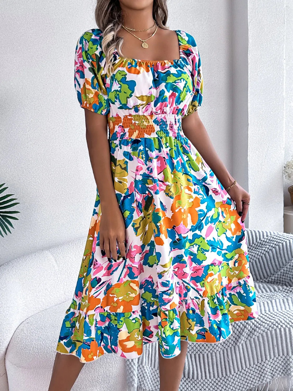 Model wearing Ruffled Hem Smocked Floral Short Sleeve Midi Dress, showcasing the elegant fit and floral pattern.