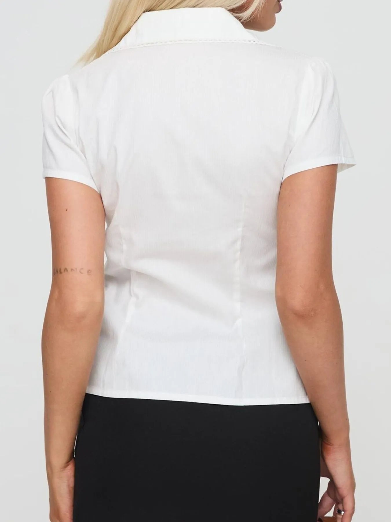 Model wearing Short Sleeve Button-Up Shirt in White