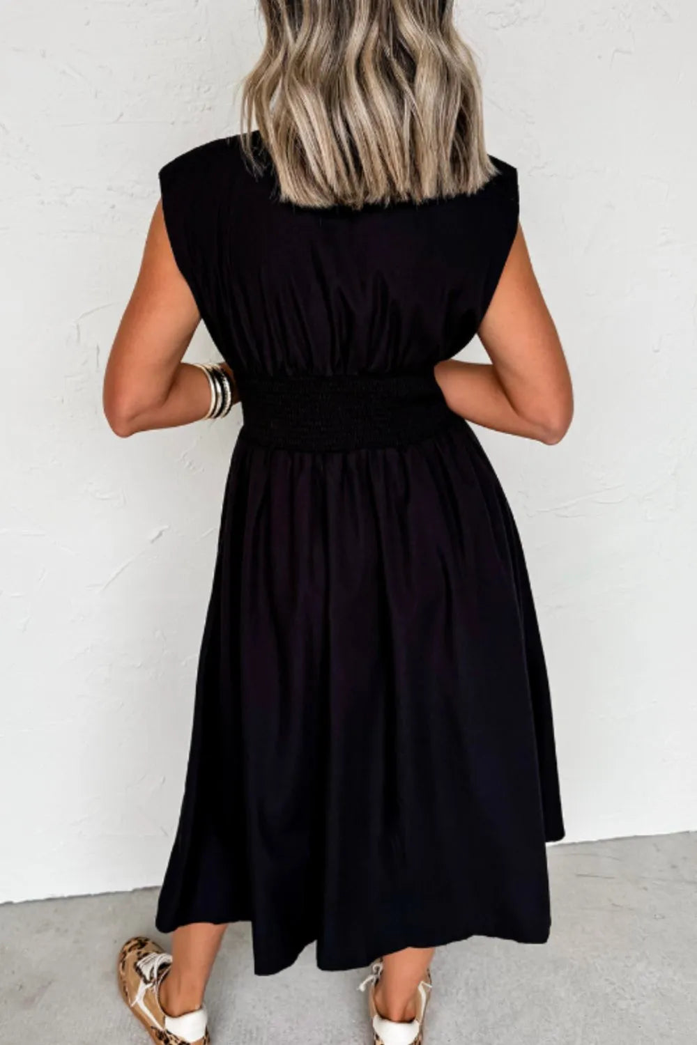 Side view showcasing the fit of Sleeveless Zip-Front Maxi Dress in Black