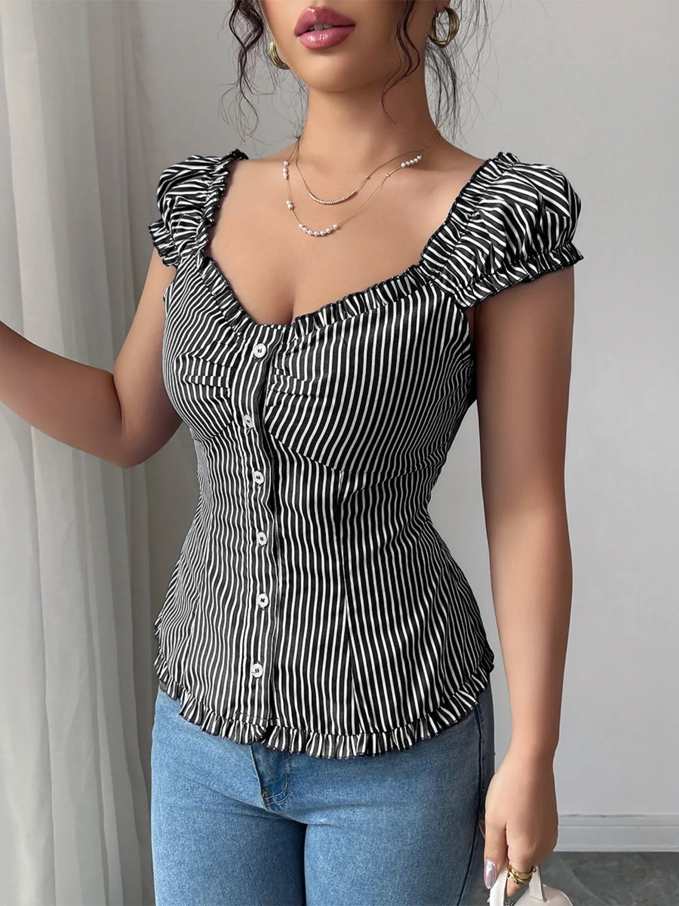 Front view of Striped Cap Sleeve Shirt in Black