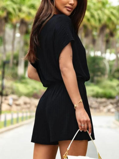 Side view showcasing the fit of Surplice Short Sleeve Romper in Black