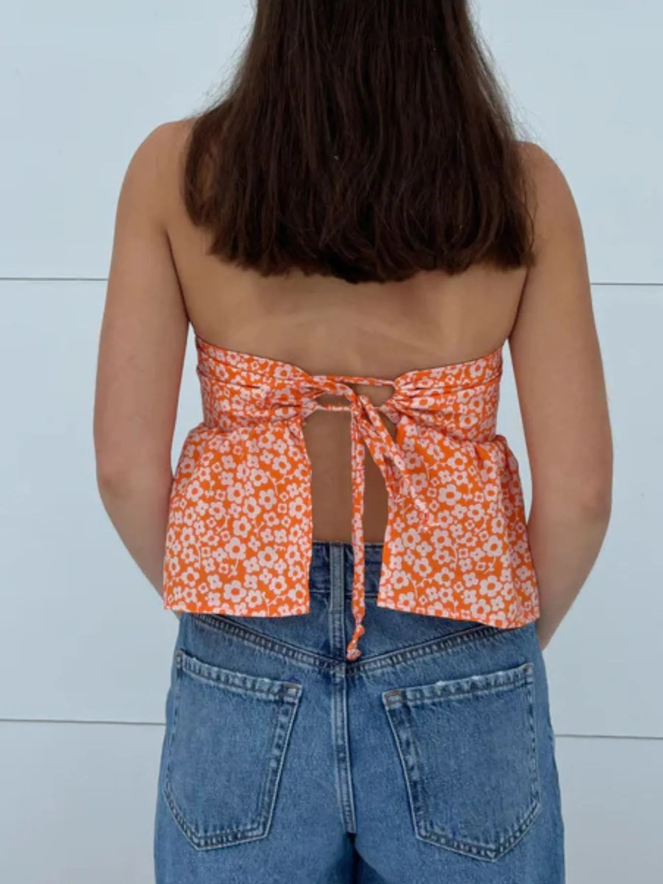 Back view highlighting the design of Tie Back Tube Top in Orange