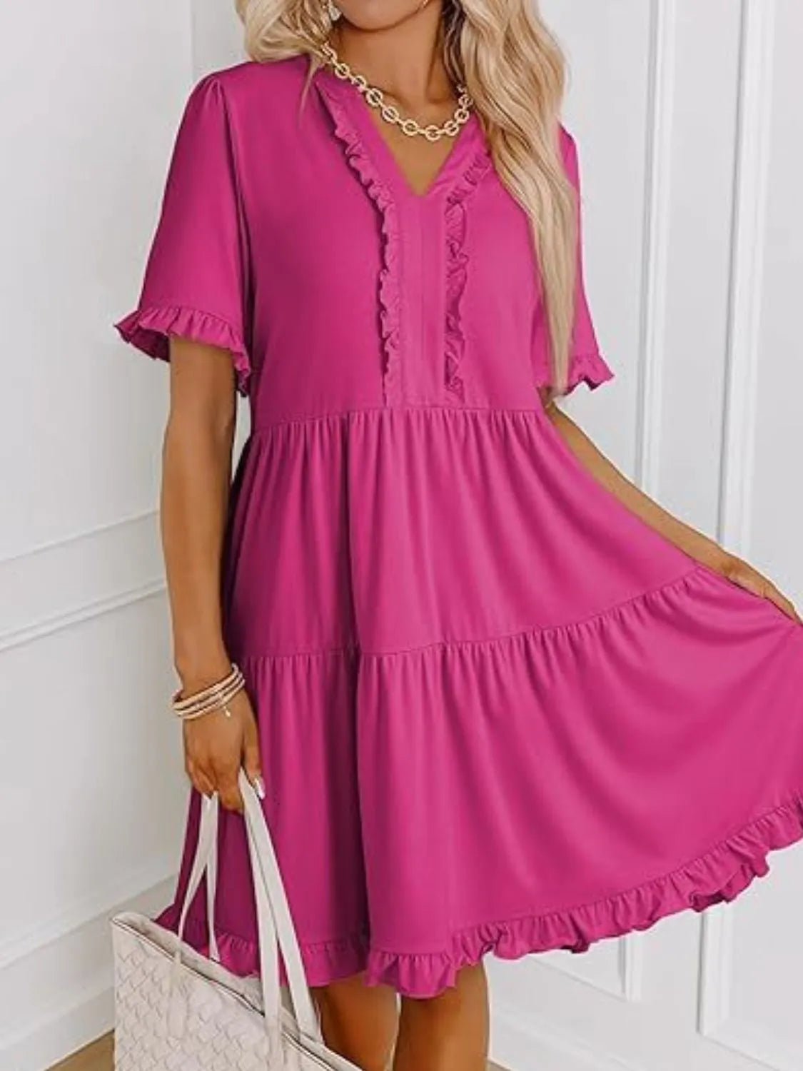 Side view showcasing the fit of Tiered Notched Short Sleeve Mini Dress in Hot Pink