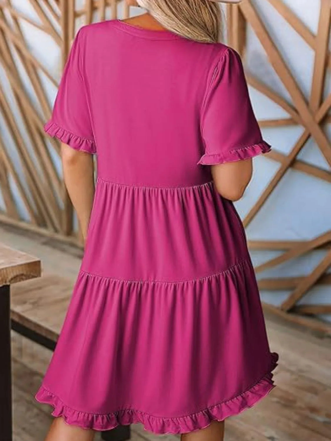Back view highlighting the design of Tiered Notched Short Sleeve Mini Dress in Hot Pink