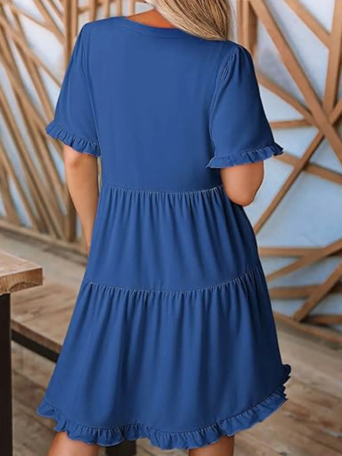 Back view highlighting the design of Tiered Notched Short Sleeve Mini Dress in Royal Blue