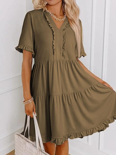 Side view showcasing the fit of Tiered Notched Short Sleeve Mini Dress in Taupe