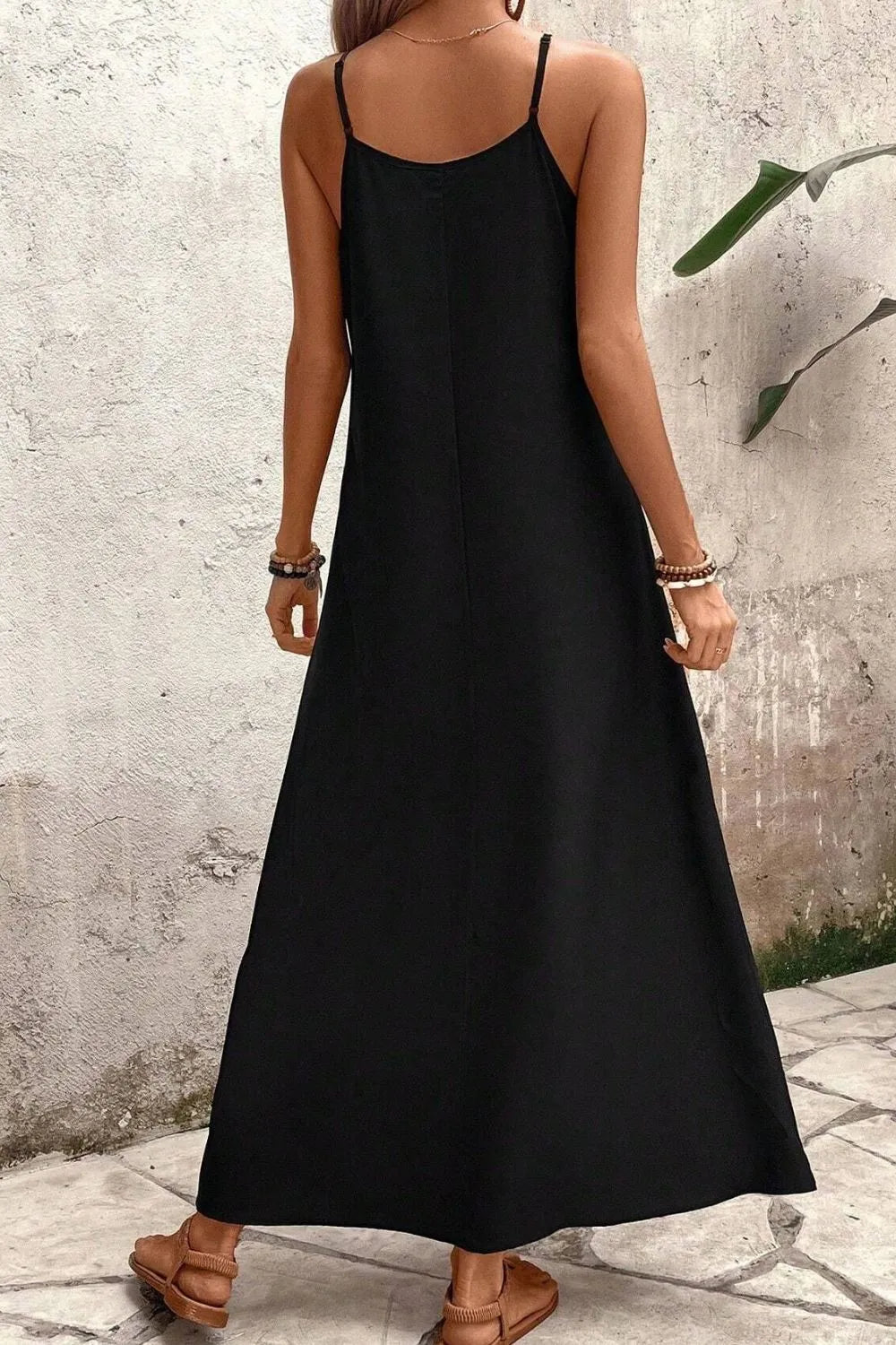 Back view highlighting the design of Tropical Leaf Print V-Neck Maxi Cami Dress in Black