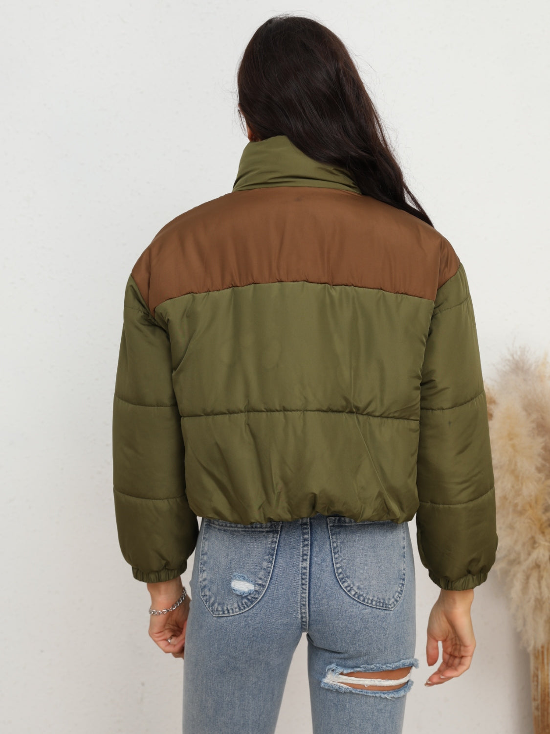 Side view of Two-Tone Zip-Up Puffer Jacket, highlighting the warm puffer fabric and stylish two-tone details.