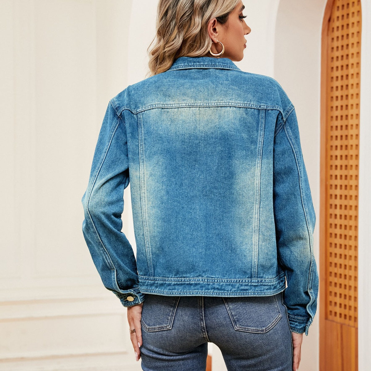 Side view of Washed Denim Jacket, showcasing the relaxed fit and timeless denim look.